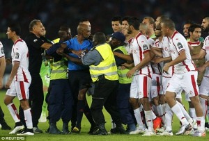 Tunisia players forward beat referee Rajindraparsad Seechurn after controversial penalty against Equatorial Guinea.