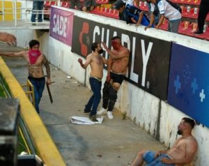 Fans of Mexican clubs Queretaro and Atlas clash during a football match